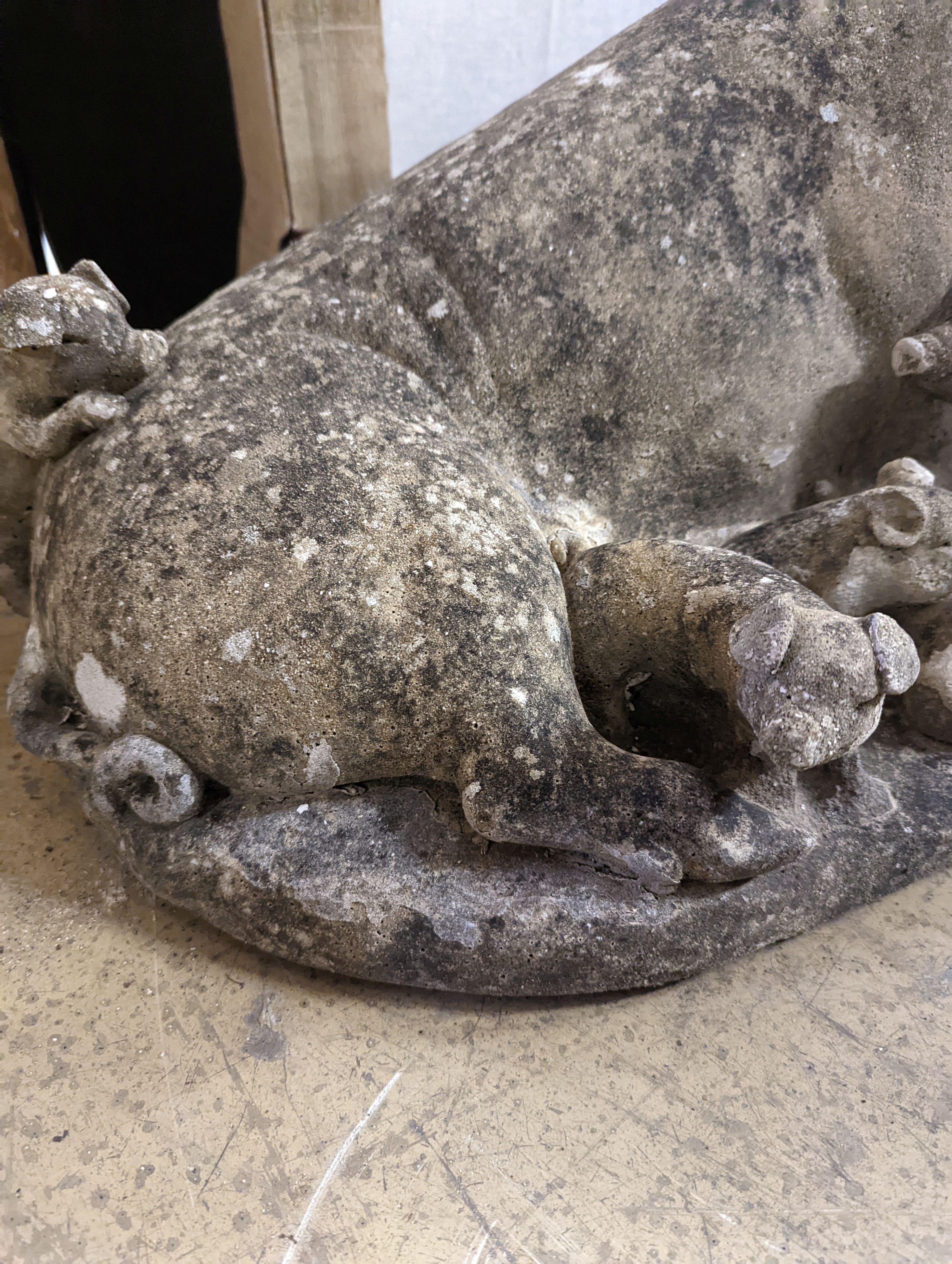A reconstituted stone garden ornament of a sow with piglets, width 56cm, height 35cm